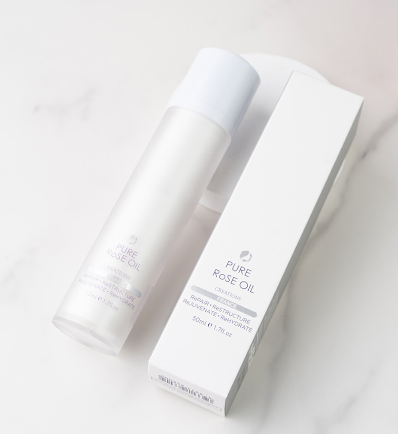 White bottle and box of Pure Rose Oil on a light gray background CUTHYS Pure 玫瑰幹細胞精華油 50ml