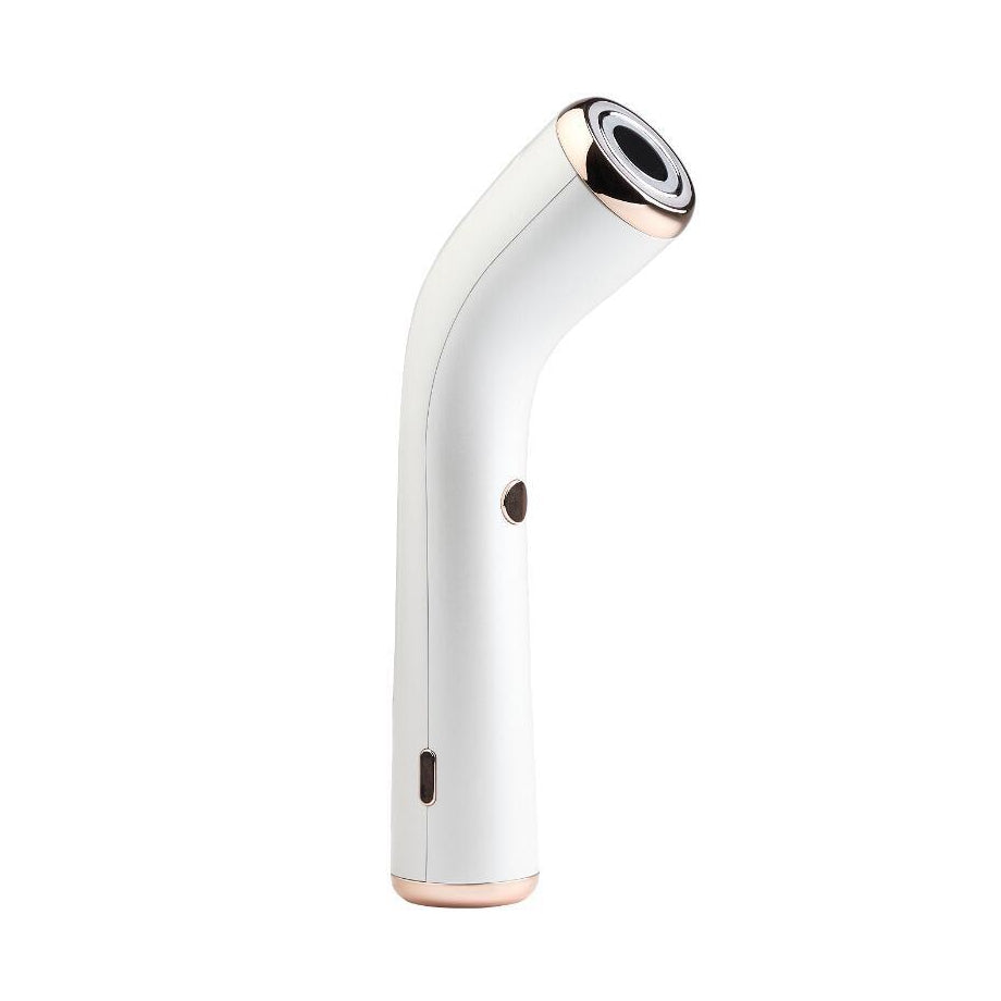 A white handheld beauty device with a curved handle, metallic rose gold accents, and a circular black-and-silver face, shown on a plain white background.